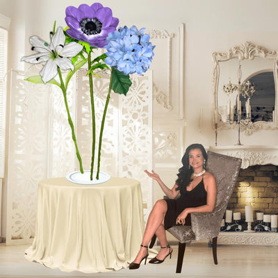 Restful Comfort Tall Table Centerpiece – White Lily, Blue Hydrangea, and Purple Anemone, 12" and 18" Diameter Flowers